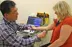 Electromyography clinic where caregiver operates device to test patient’s muscle activity