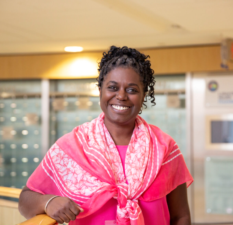 Female doctor in focus with hospital setting in background