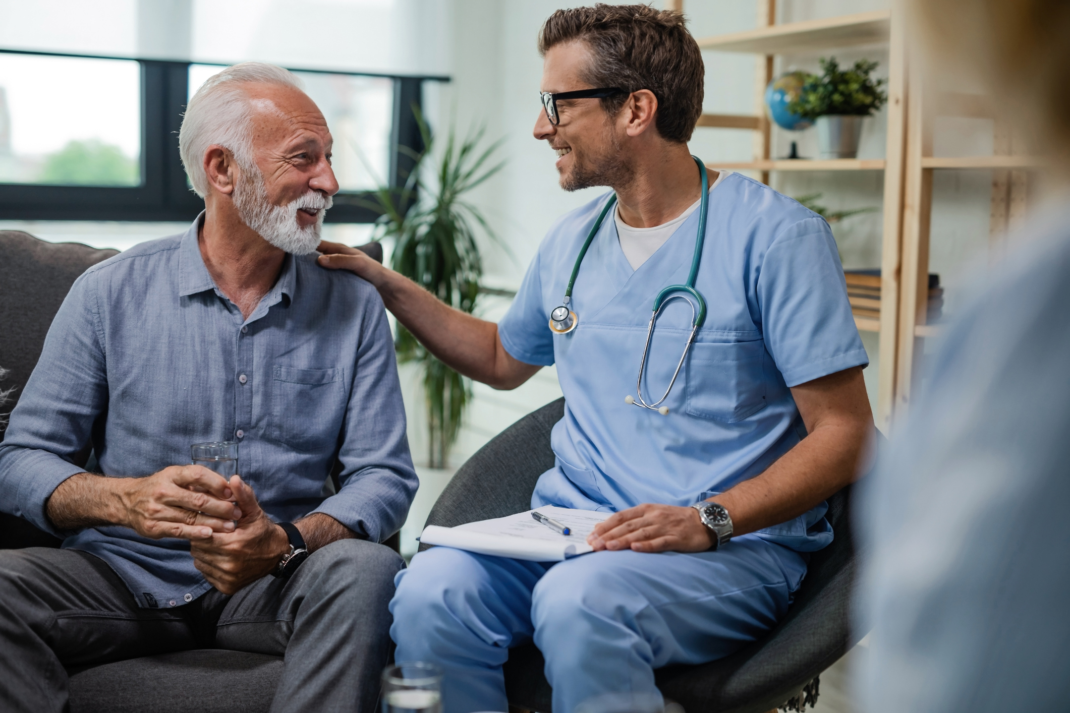 A doctor consoling and communicating with the patient, and both smiling