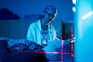 Radiation therapy procedure, patient lying while doctor conducts necessary assessment