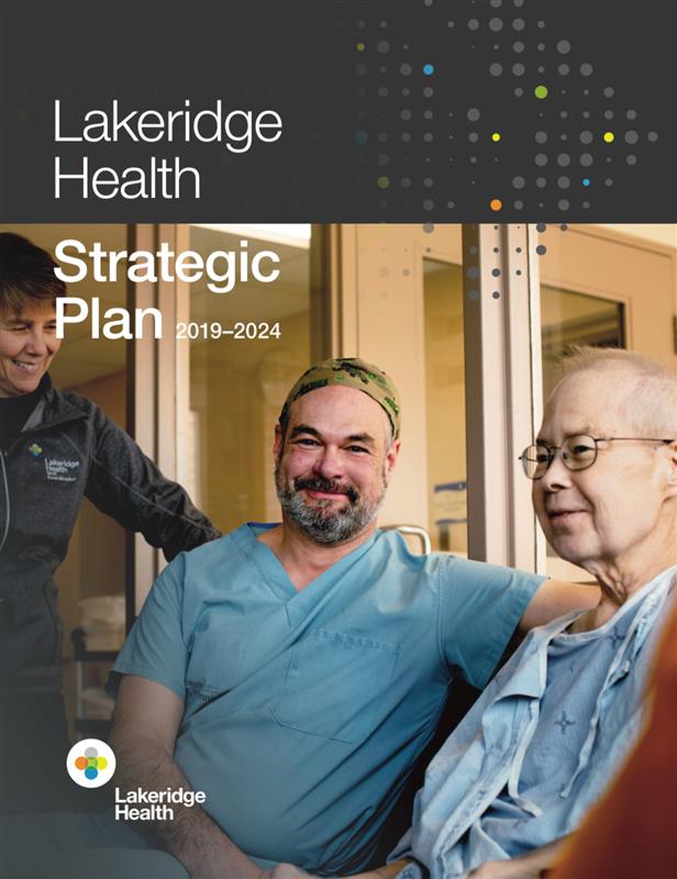 Cover of the Strategic Plan featuring a staff member in blue scrubs and a scrub cap seated beside a patient in a hospital gown. Another staff member wearing a Lakeridge Health sweater is standing beside them. Text reads: "Lakeridge Health Strategic Plan 2019-2024." The Lakeridge Health logo is in the bottom left corner.