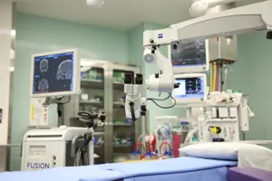 ENT clinic room equipped with diagnostic machine, monitoring screen, and patient examination bed