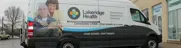 Ambulance vehicle fully wrapped with Lakeridge Hospital promotional advertisement graphics